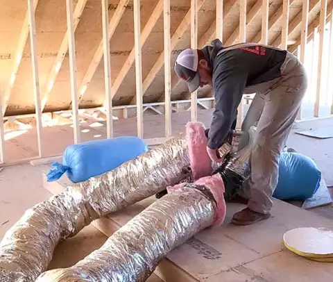 One of our techs setting up the duct work for a customer's home